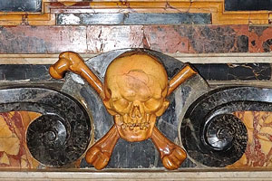 Skull and Crossbones of orange color decorate the dilapidated tomb