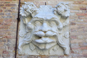 The face of fabulous creature is on the wall inside the garden of Ducal Palace