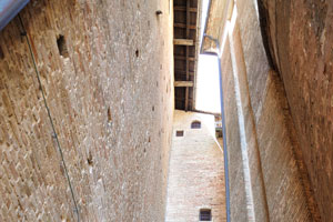 An impressive narrow passage lies between the high buildings