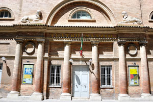 Egyptian statues of lions adorn the facade of Teatro Sanzio