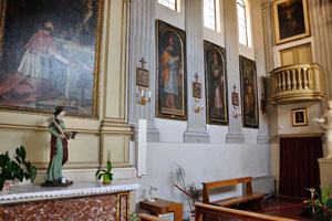 Paintings are on the wall in the catholic church
