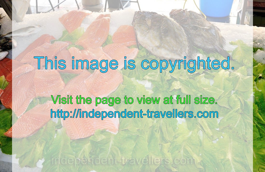 Red fish fillet is placed on green leaves for better appearance