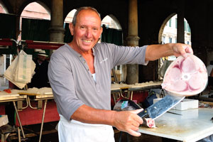 The wonderful vendor shows a fresh slice from a swordfish