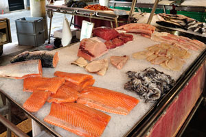 Different kinds of fish fillet are on the counter