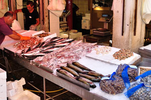 Rialto fish market: seafood vendor is laying out the catch