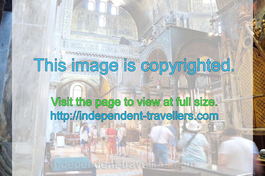 Tourists admire the majestic beauty of the inner interior of the Saint Mark's Basilica