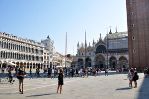Pigeons and walking tourists on the St Mark's Square