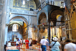 Tourists admire the majestic beauty of the inner interior of the Saint Mark's Basilica