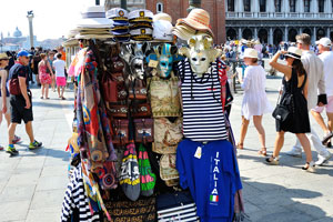 Vendors set up a stall on the St Mark's Square to sell colorful masks