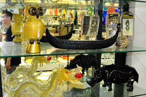 Owl, dragon and rhino glass statues inside the shop on the Calle Bressagio street on Murano
