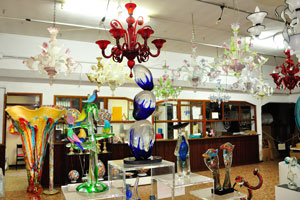 Different glass statues of huge sizes in the shop on Murano