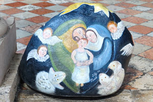 The round stone with an image of baby Jesus in the Santo Stefano church