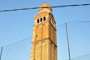 The bell tower of the Madonna dell'Orto church has a cell with circular mullioned windows on its top