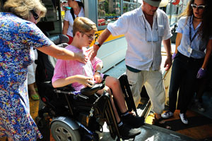 Guy with disabilities drives electric wheelchair on the Rialto vaporetto station