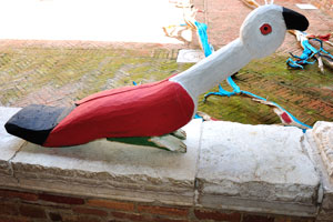 A wooden bird sculpture looks a little bit funny