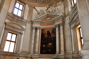 Statues of the angels sitting above the painting in the church of San Giorgio Maggiore