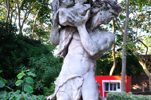 Statue of a boy carrying huge stone is located in the Giardini