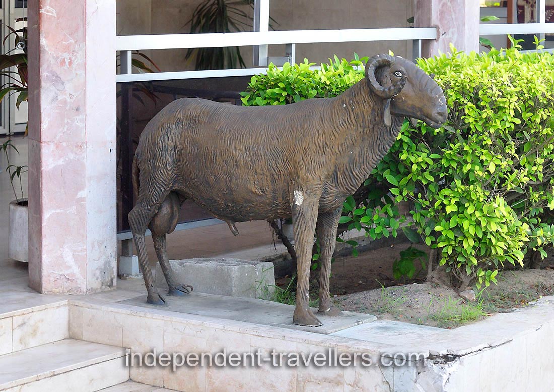 A statue of ram is at the entrance to Hotel Nouvelle Pergola