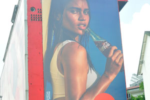 Coca-Cola advertisement is in the city