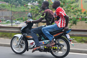 Two motorcyclists are somewhere between the districts of Cocody and Marcory