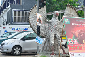 A funny bird statue is on the road