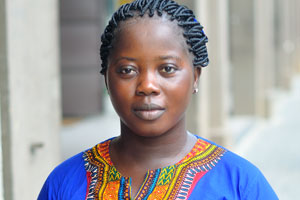 An Ivorian young woman is dressed in the national T-shirt