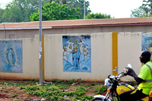 Fence around the Cathedral of St. John the Baptist in Korhogo is painted with the Christian drawings