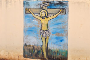 This fence painting of the Cathedral of St. John the Baptist depicts Jesus on the Cross