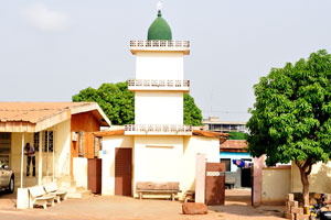 A small mosque has a green dome