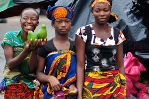 Charming female street vendors sell avocado
