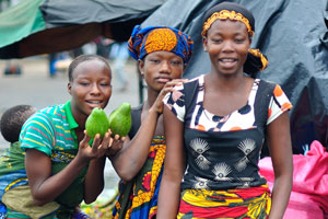 Pretty young female street vendors show their avocados for me