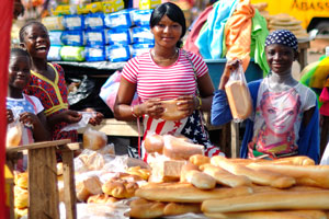 Lovely female vendors sell bread at the bus station of Gare Routiere
