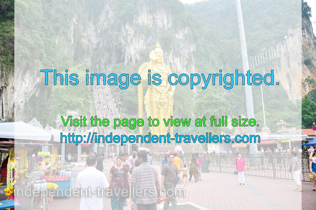 Approaching the caves, the first thing you notice is a towering golden statue of Lord Murugan
