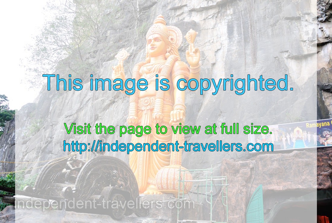Golden krishna statue at the entrance to the Ramayana cave