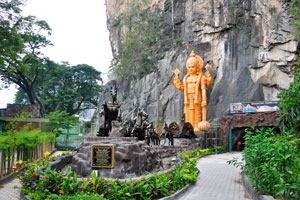 Ramayana cave is situated to the extreme left as one faces the sheer wall of the hill