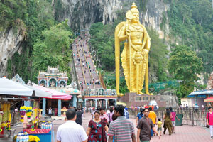 Approaching the caves, the first thing you notice is a towering golden statue of Lord Murugan