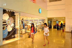 Two girls are laughing out loud while shopping inside Berjaya Times Square