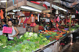 Narrow pathways go through maze of stalls full of fish and meat, fruits and vegetables, spices
