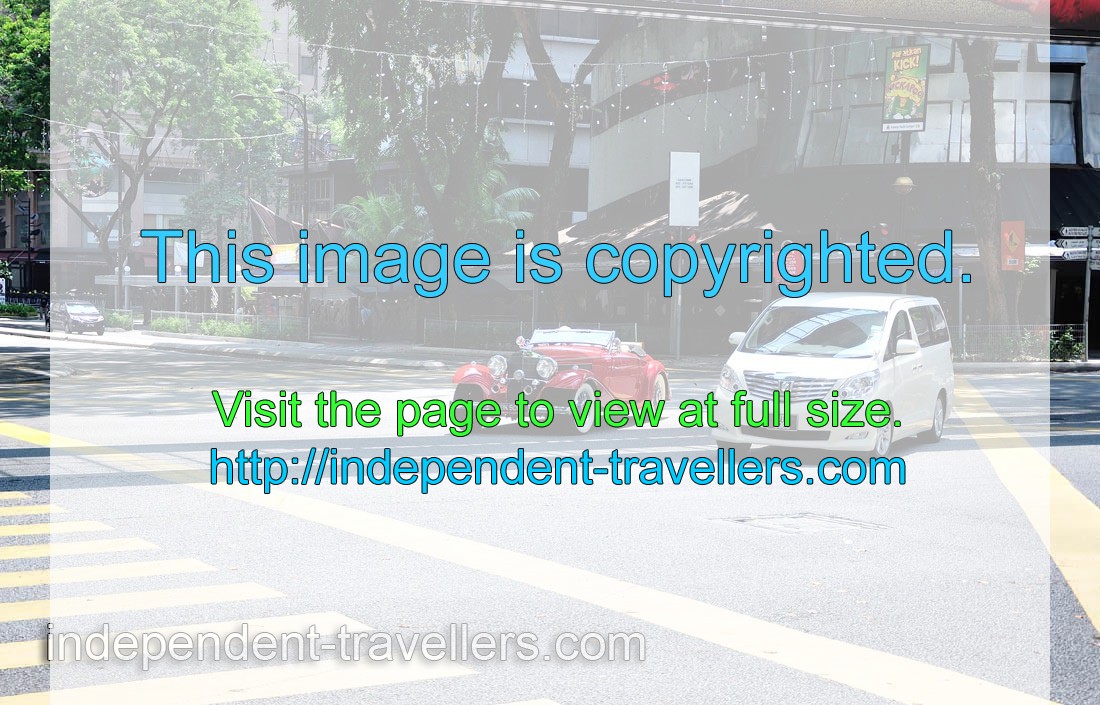 Vintage car drives on the intersection of Jalan Sultan Ismail and Jalan P Ramlee