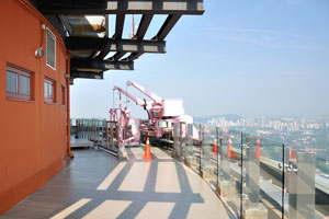 Small pink crane at the open observation deck