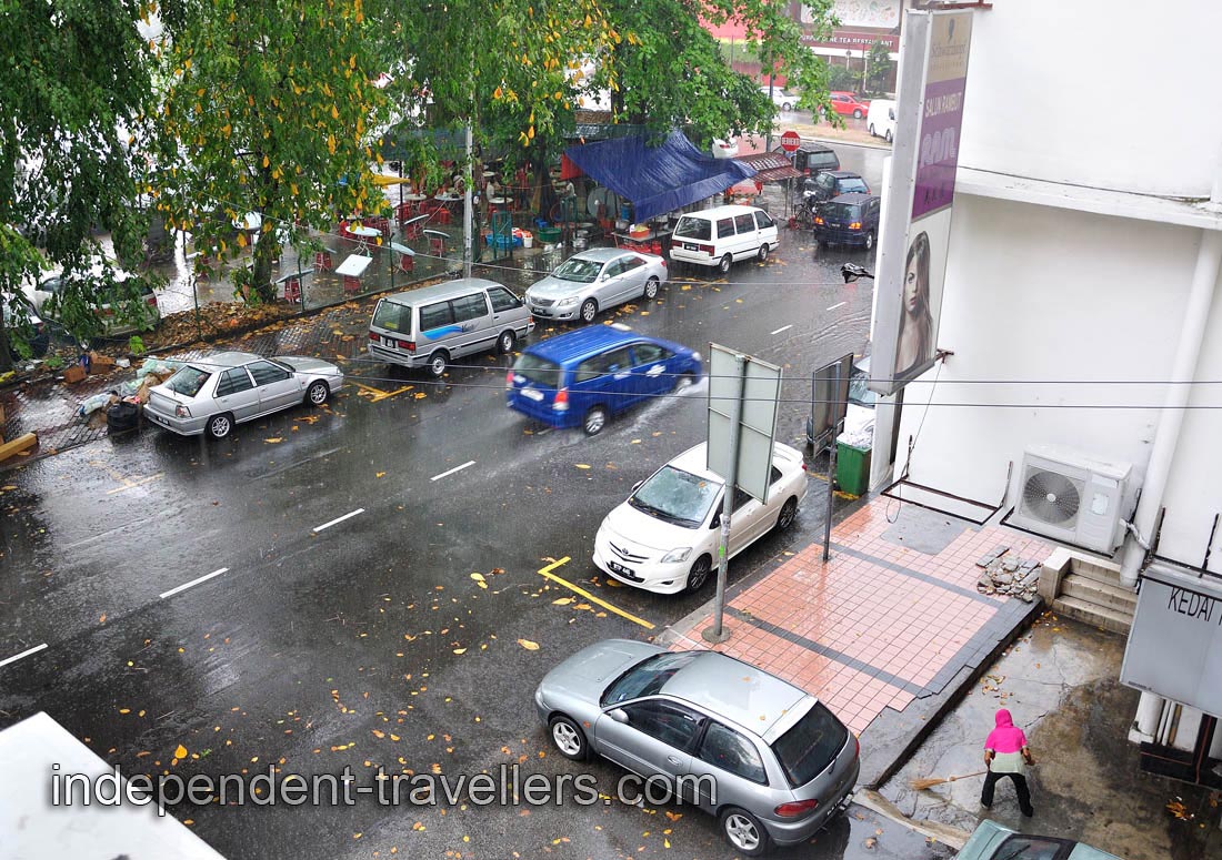 We can watch the downpour from our room's window in 88 Inn