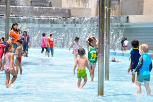 Little malaysian girls and little white boy are enjoying water