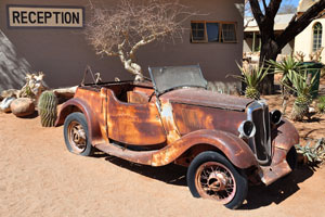 A vintage car is situated near the reception of the Solitaire Lodge