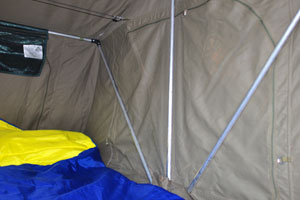 The blue-yellow sleeping bag is inside the car roof top tent where I slept at the camping pitch in Palm Camp