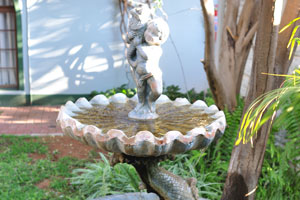 A tiny garden fountain creates the special atmosphere in the Onze Rust Guest House