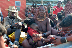 An attractive Himba woman is at the entrance to the Opuwo District Hospital
