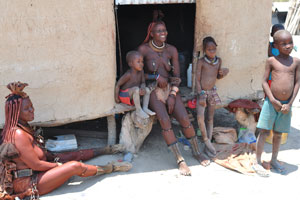 A smiling Himba women and children
