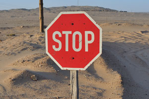 A stop sign is placed near the gates to Kolmanskop