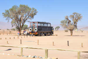 A large bus with tourists arrived in Sesriem Campsite and rented a camping pitch