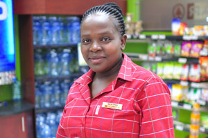 A gorgeous Namibian female vendor works in Spar grocery store
